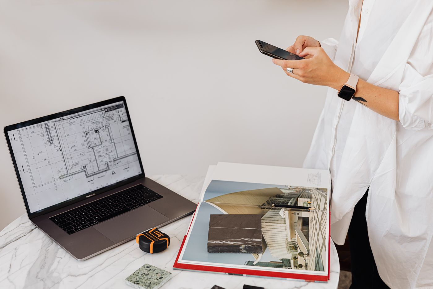 Requesting a tax depreciation quote at a desk with laptop and building plans
